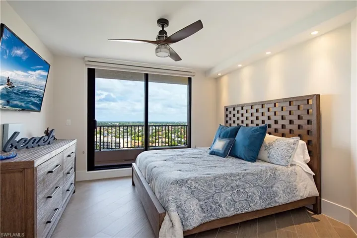 Second Bedroom with King Size Mattress. and featuring access to exterior, recessed lighting, wood finished floors, floor to ceiling windows, and ceiling fan