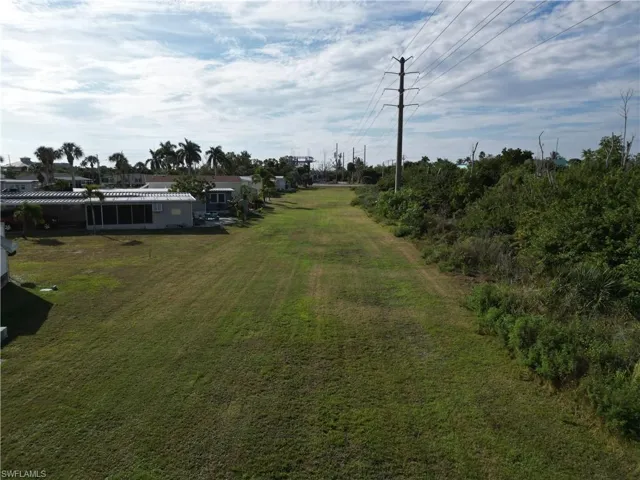 Looking South across the large grassy area to the rear of the lot