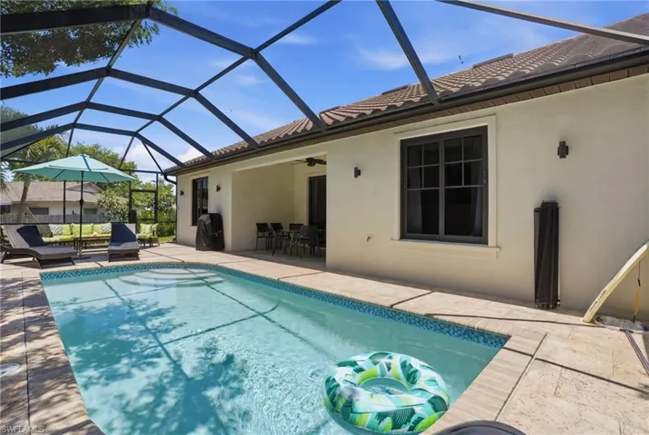 Private screened lanai featuring a sparkling heated saltwater pool.