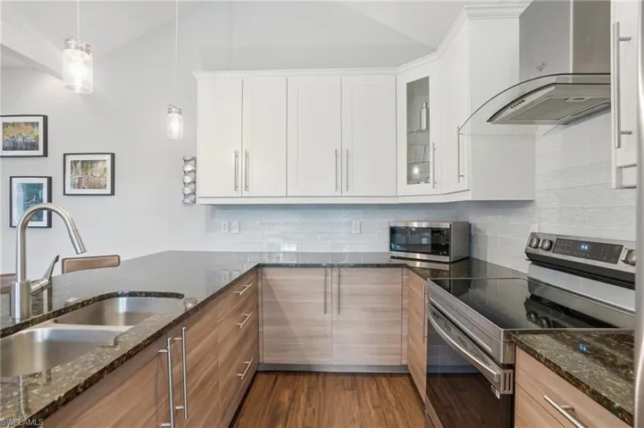 Modern kitchen with stainless steel appliances and ample storage.