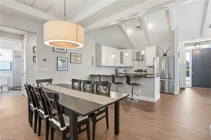 Elegant dining area overlooking the pool, ideal for family gatherings and dinner parties.