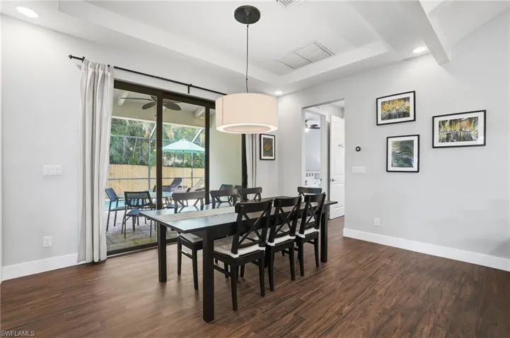 Dining area overlooking the pool, ideal for family gatherings and dinner parties.