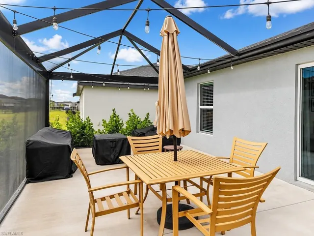 Screened patio featuring a concrete slab and string lighting