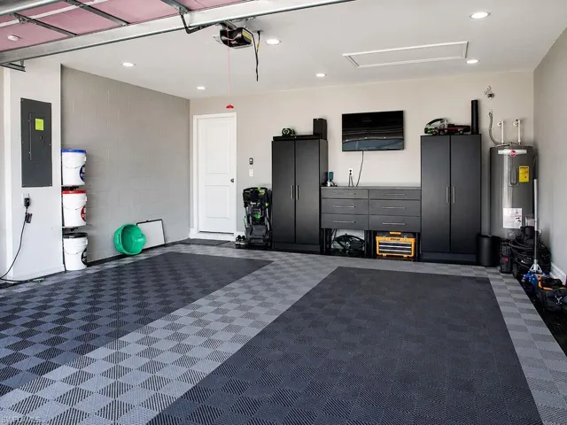 Spacious garage with checkered tile flooring, recessed lighting, white interior door