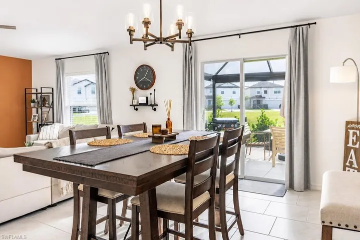 Open-concept dining area featuring a dark wood-finish dining table and coordinated chairs