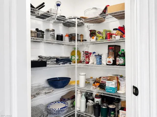 Corner pantry with white wire shelving providing extensive storage capacity