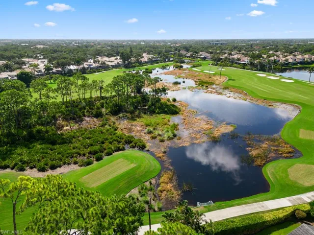 Bird's eye view with a water and golf view