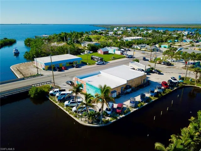 Birds eye view of property with a water view