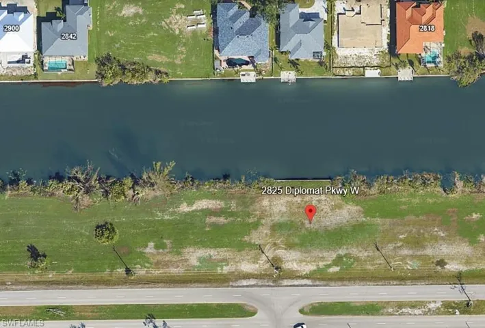 Expansive waterfront lot featuring direct canal frontage and direct road access