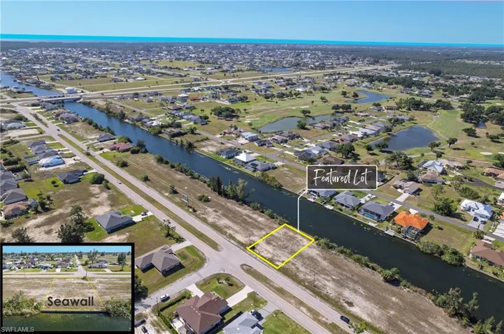 Canal-front lot featuring a seawall and surrounding residential properties