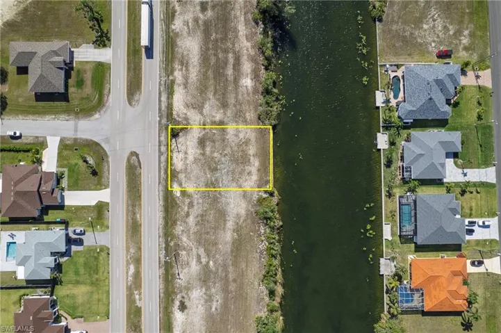 Cleared lot with water access, situated on a canal with direct access to a paved roadway