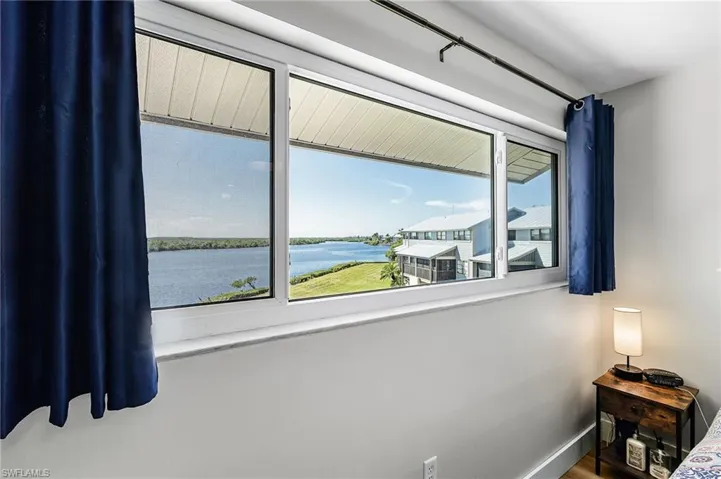 Bedroom with a water view and baseboards