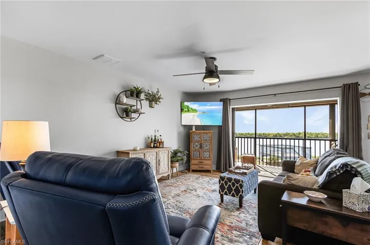 Living area with wood finished floors and a ceiling fan