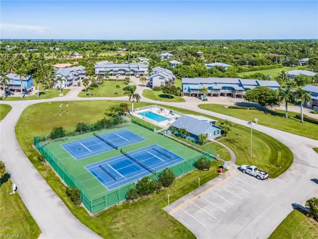 Aerial perspective of suburban area featuring a pool