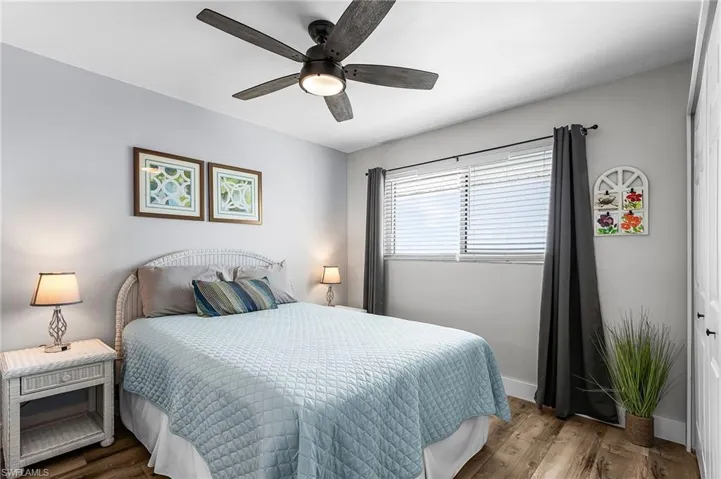 Bedroom featuring wood finished floors and a ceiling fan