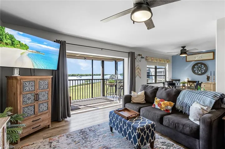 Living area with wood finished floors and ceiling fan