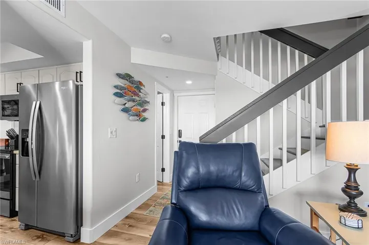 Staircase featuring wood finished floors and baseboards