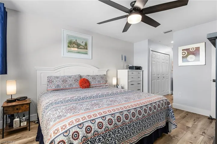 Bedroom featuring light wood-style flooring, ceiling fan, and a closet