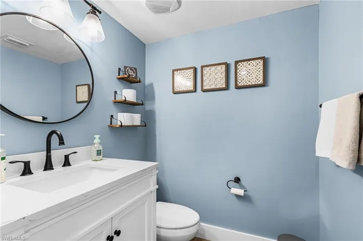 Half bath with vanity and toilet