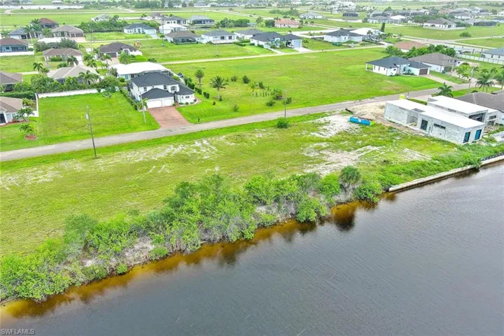 Aerial perspective of suburban area with a nearby body of water