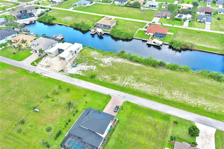 Aerial perspective of suburban area with a large body of water