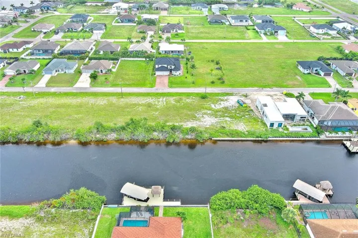 Aerial view of residential area featuring a large body of water