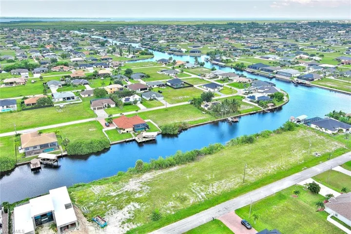 Aerial perspective of suburban area featuring a large body of water