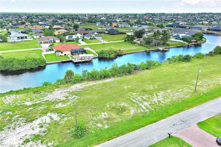 Aerial perspective of suburban area with a nearby body of water