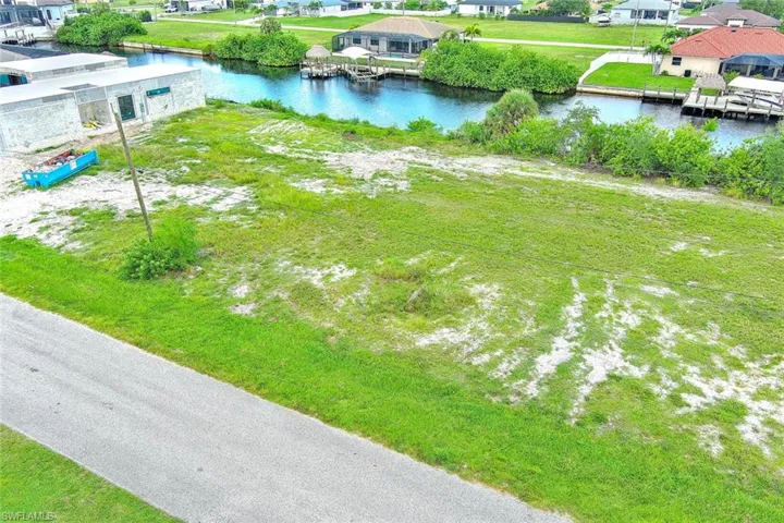 Aerial perspective of suburban area featuring a large body of water