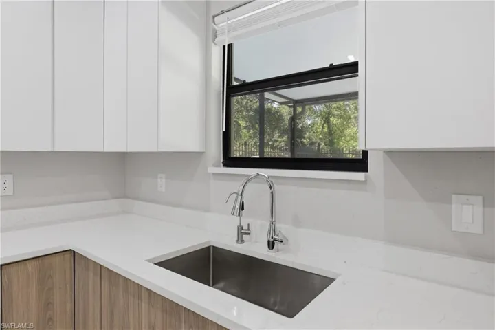 Modern kitchen featuring an undermount stainless steel sink with a gooseneck faucet
