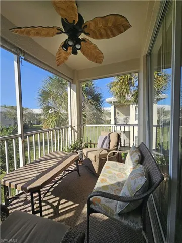Sunroom / solarium featuring a ceiling fan, a balcony, and outdoor seating
