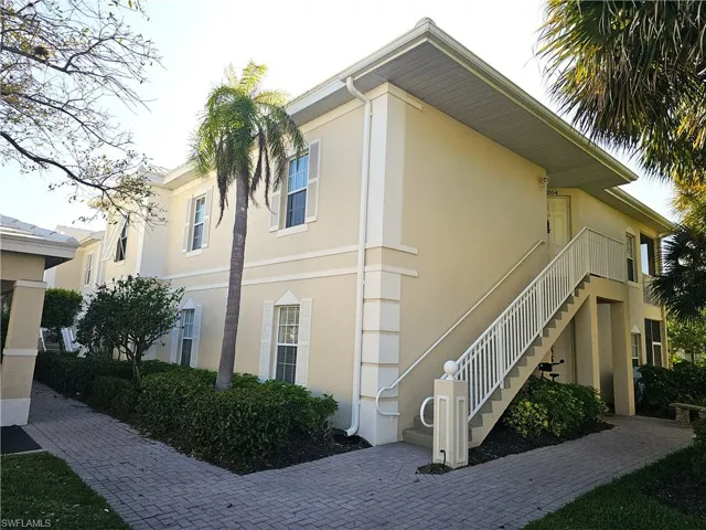 View of home's exterior featuring stairs and stucco siding