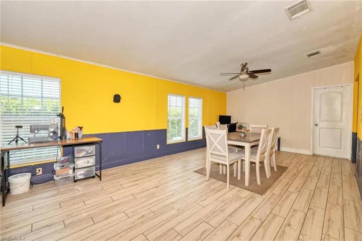 Dining room with ceiling fan and light wood-type flooring