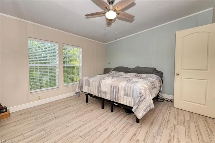 Bedroom featuring crown molding, ceiling fan, and light hardwood / wood-style floors