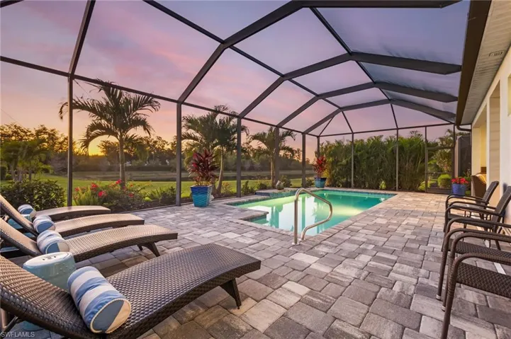 Outdoor pool with a lanai and a patio