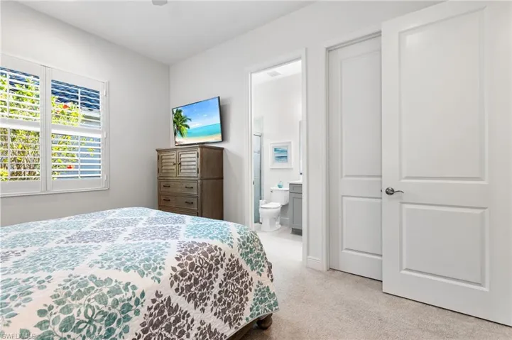 Bedroom with carpet flooring and ensuite bathroom