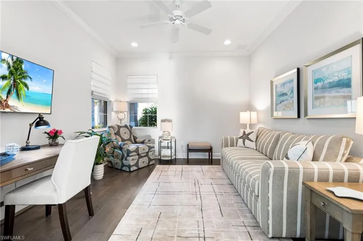 Living area with recessed lighting, light wood-style floors, and crown molding