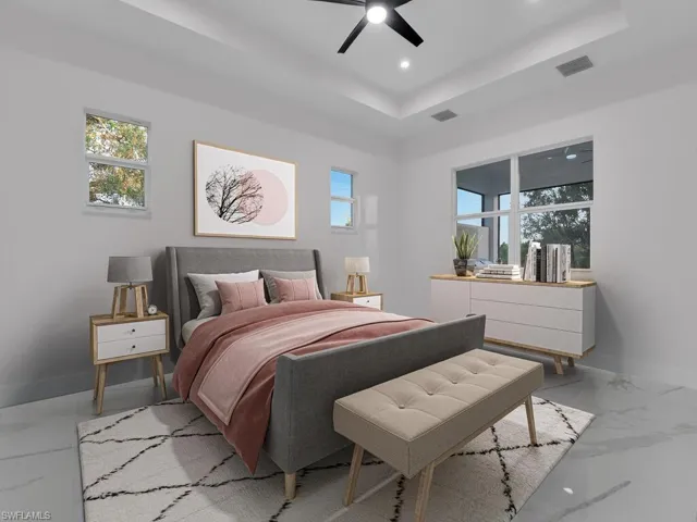 primary Bedroom featuring a tray ceiling and ceiling fan, furnitures are not included.