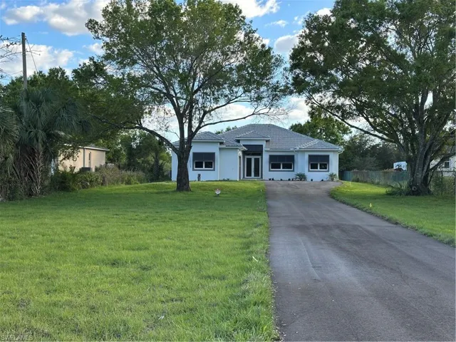 Single story home featuring a front yard, impact windows and doors. !.14 acres lot.