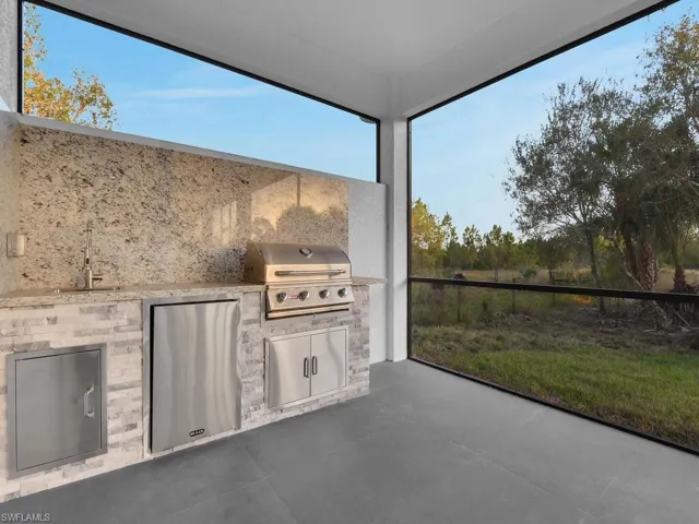 View of patio / terrace with area for grilling, a grill, and sink