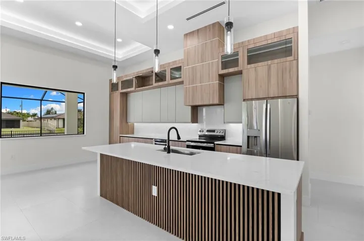 Kitchen featuring an island with wood-finish slat paneling, a white countertop, and a black gooseneck faucet
