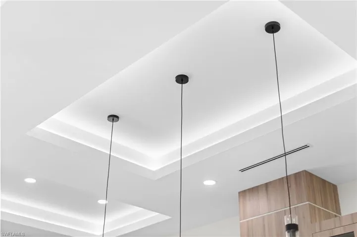 Tray ceiling with integrated lighting, recessed lighting, and suspended pendant lights