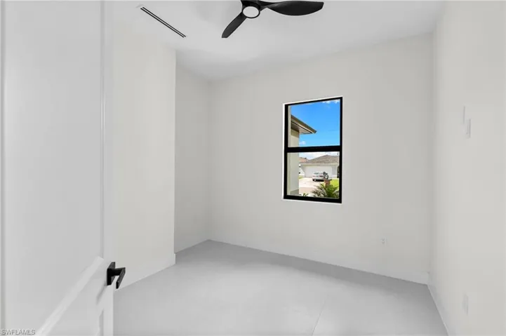 White walls, light-toned flooring, and a ceiling fan