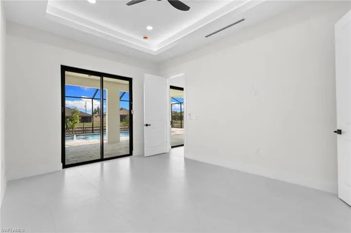 Sliding glass doors opening to a screened patio and swimming pool