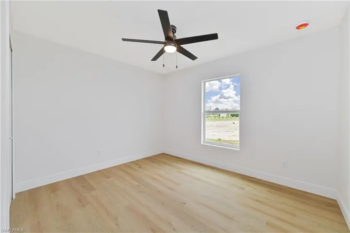 Unfurnished room featuring light wood-style floors and ceiling fan