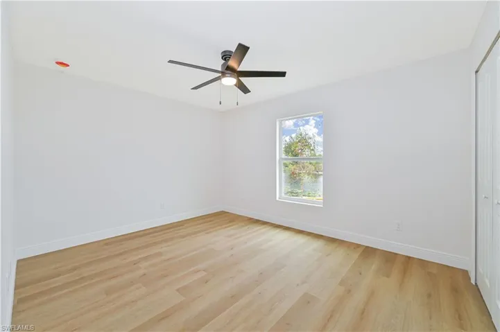Spare room with light wood-style flooring and ceiling fan