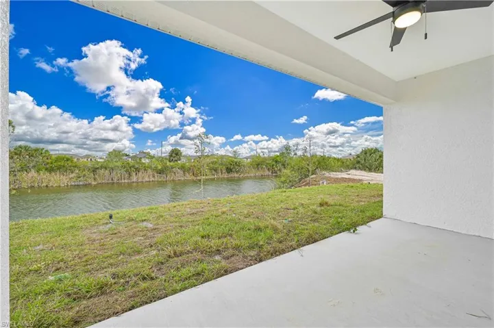 View of patio with a water view and ceiling fan