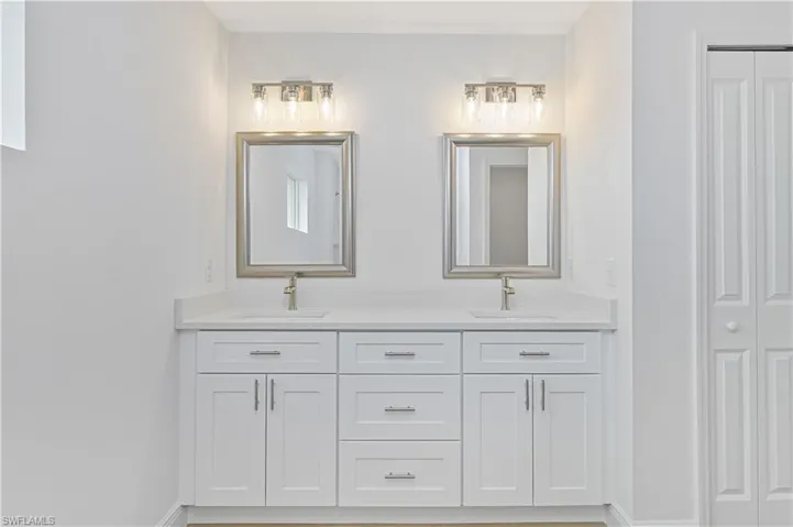 Full bathroom with a closet and double vanity