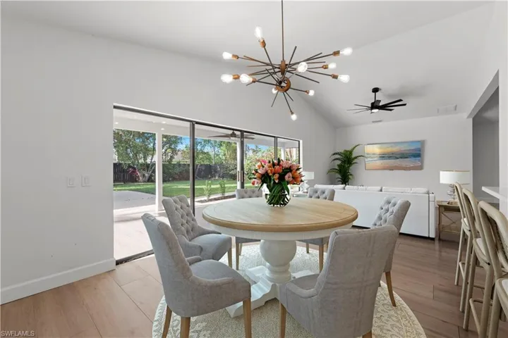 Dining Area, kitchen, and family room. Large Sliders open to outdoor entertaining area and backyard. Virtually Staged