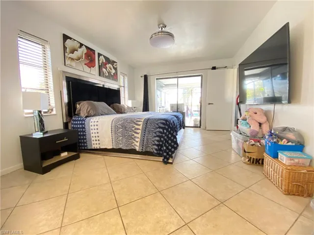 Master Bedroom with access to outside and light tile patterned floors